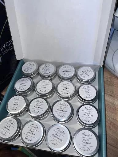 A boxed set of labeled scent tins used in the Early Scent Introduction program